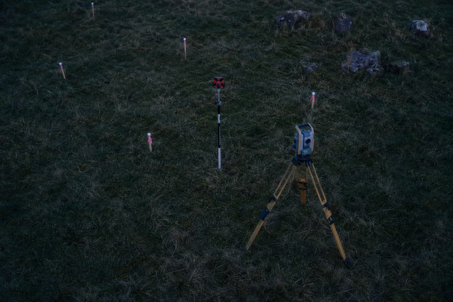 Topographic surveying instruments and markers on field tripod station